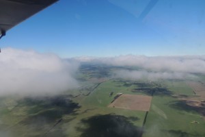 Cloud shadows on farmland below from 4800 ft