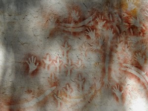 Stencil art - hands, crossed forearms, emu feet, throwing sticks